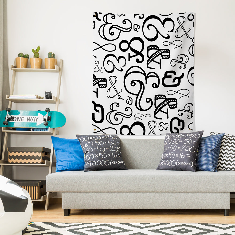 ampersand wall tapestry hung over couch