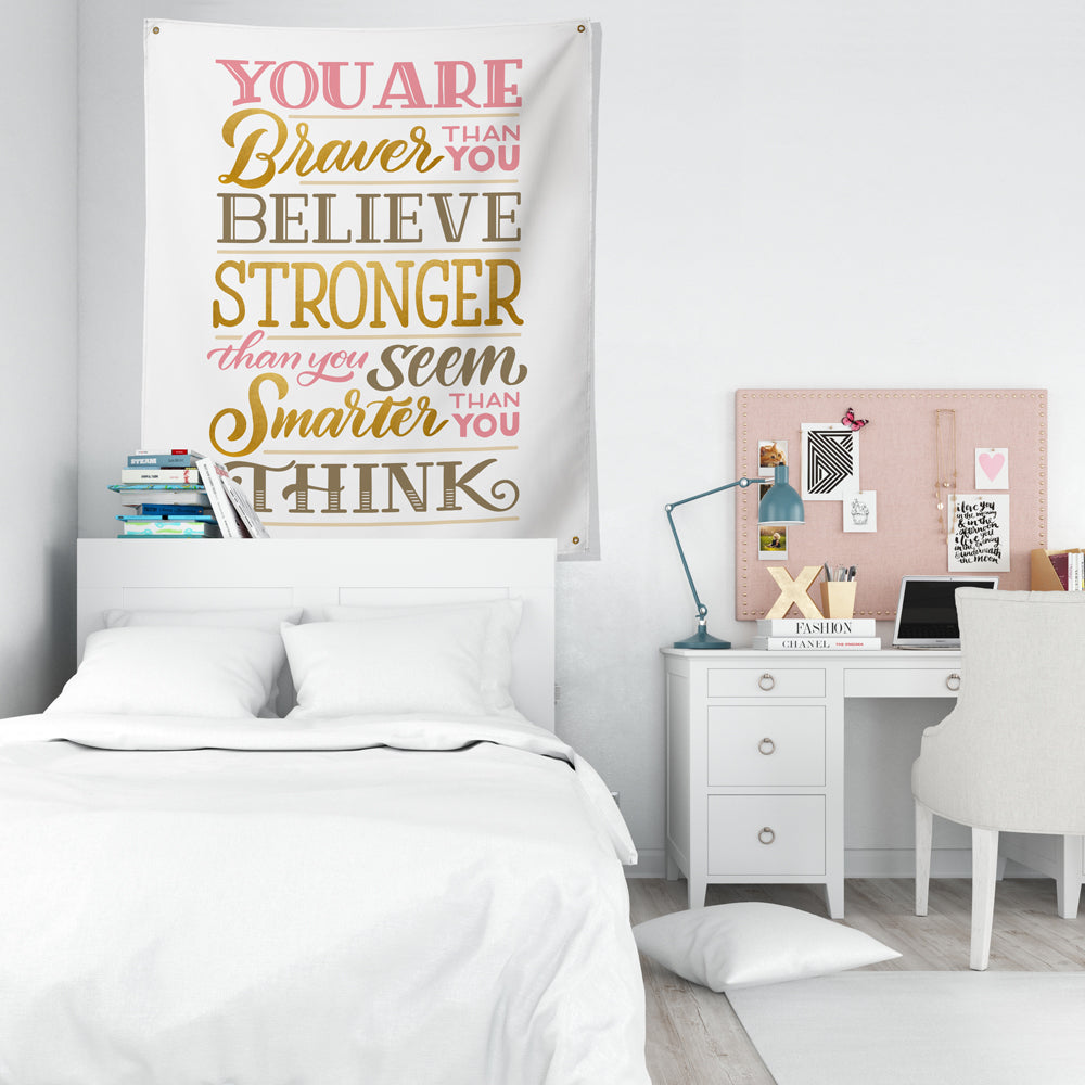 braver stronger and smarter than you think tapestry above bed