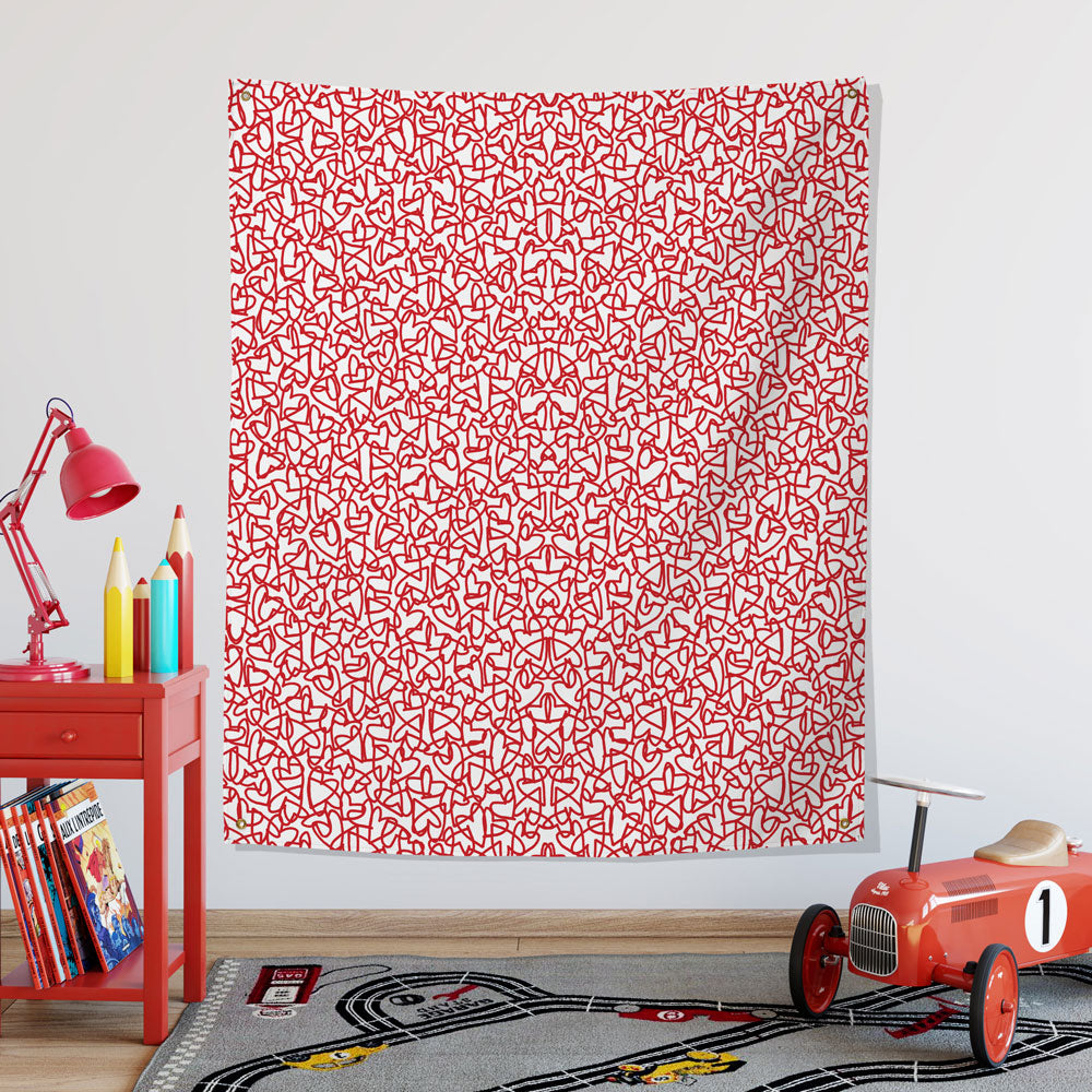 red hearts wall tapestry hung in a child's playroom 